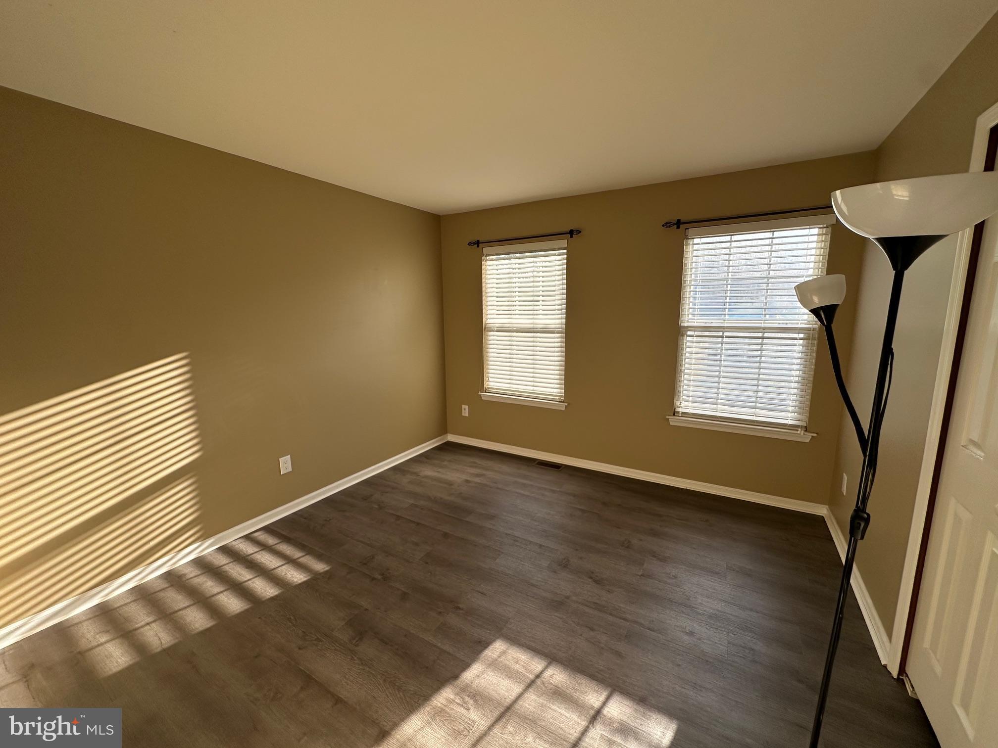 6104 Coventry Way Mount Laurel, NJ 08054 - Photo 13 of 17 a view of an empty room with glass door and wooden floor