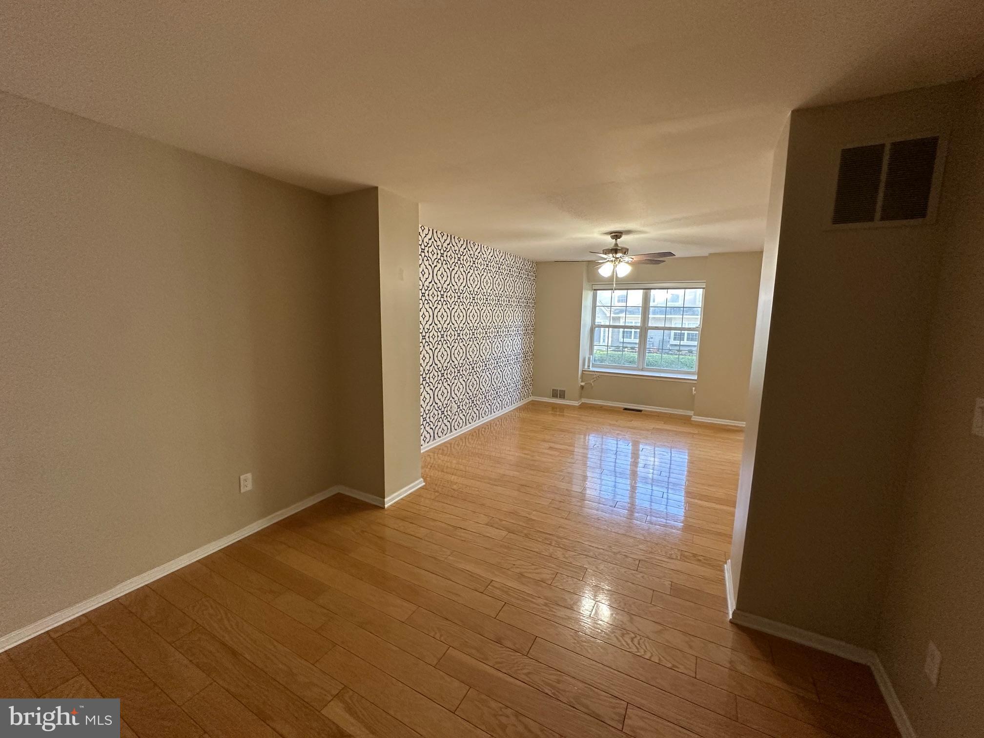 6104 Coventry Way Mount Laurel, NJ 08054 - Photo 4 of 17 an empty room with wooden floor and windows