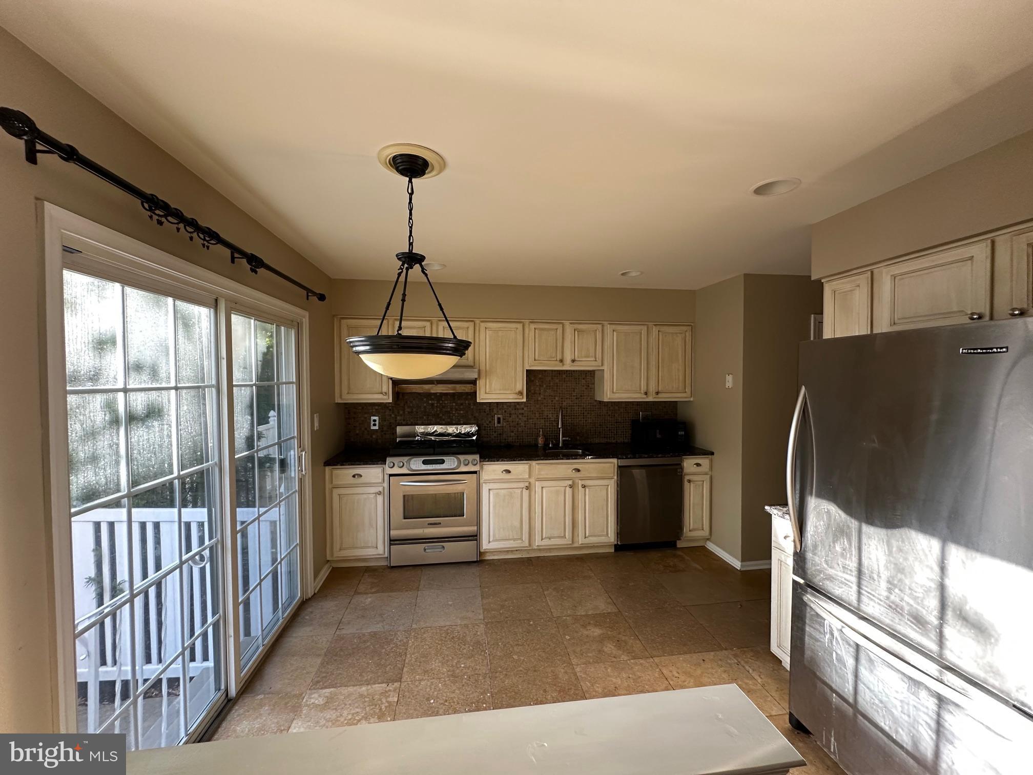 6104 Coventry Way Mount Laurel, NJ 08054 - Photo 5 of 17 a kitchen with stainless steel appliances a stove a refrigerator and a sink