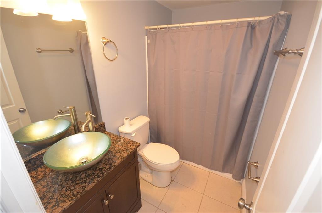 2444 Southeast Washington Street Stuart, FL 34997 - Photo 11 of 13 a bathroom with a toilet a sink and a mirror