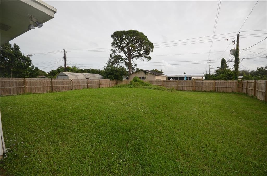 2444 Southeast Washington Street Stuart, FL 34997 - Photo 13 of 13 a backyard of a house with lots of green space