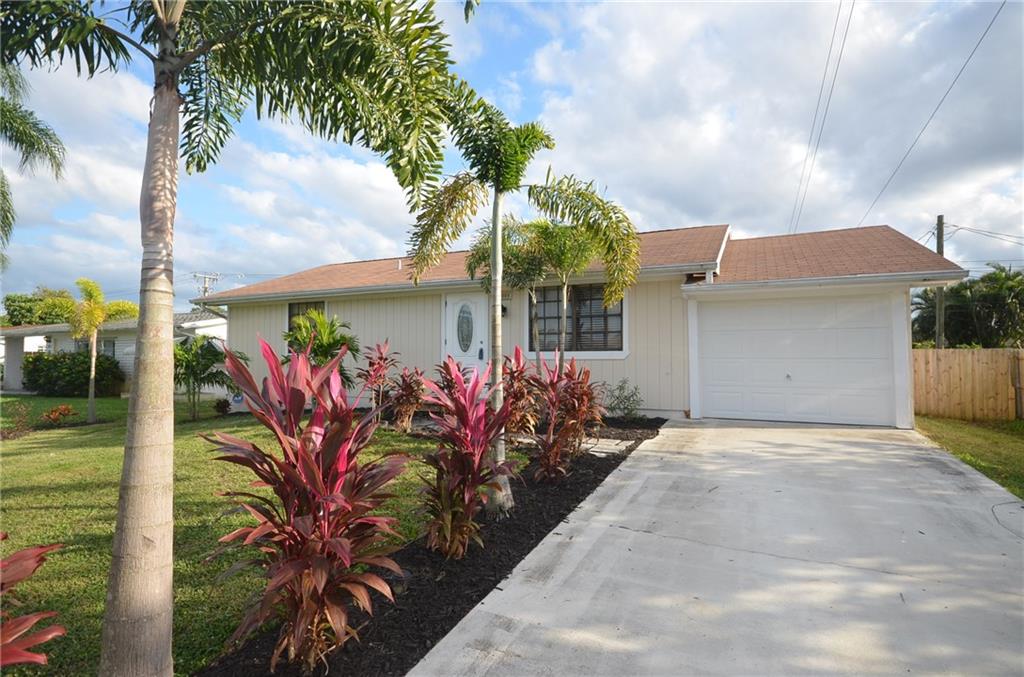 2444 Southeast Washington Street Stuart, FL 34997 - Photo 2 of 13 front view of a house with a yard