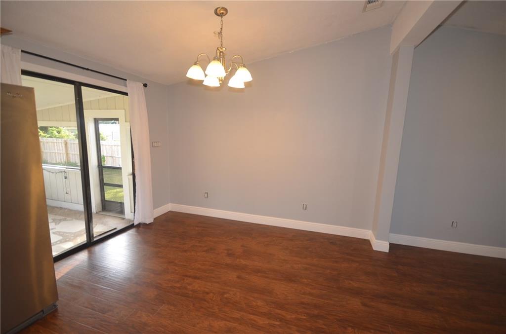 2444 Southeast Washington Street Stuart, FL 34997 - Photo 4 of 13 an empty room with wooden floor and windows