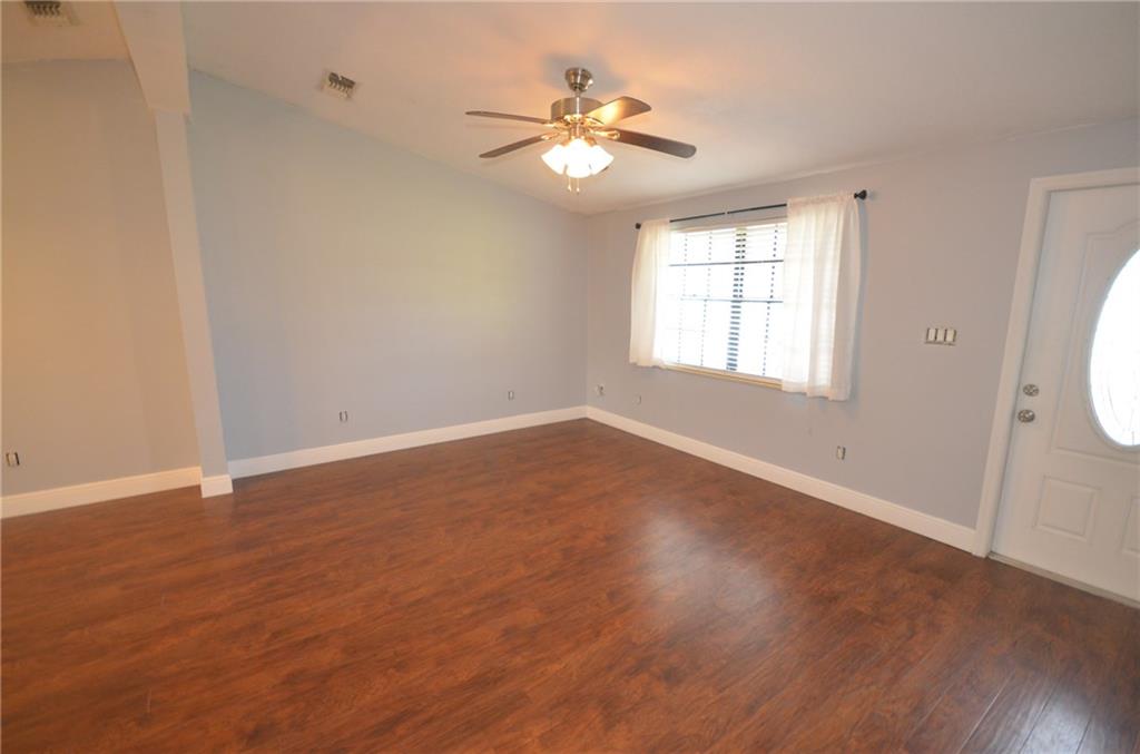 2444 Southeast Washington Street Stuart, FL 34997 - Photo 5 of 13 an empty room with wooden floor and windows