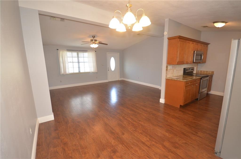 2444 Southeast Washington Street Stuart, FL 34997 - Photo 6 of 13 wooden floor in an empty room with a window