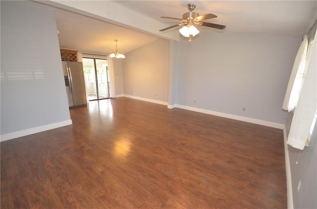 2444 Southeast Washington Street Stuart, FL 34997 - Photo 7 of 13 wooden floor in an empty room with a window