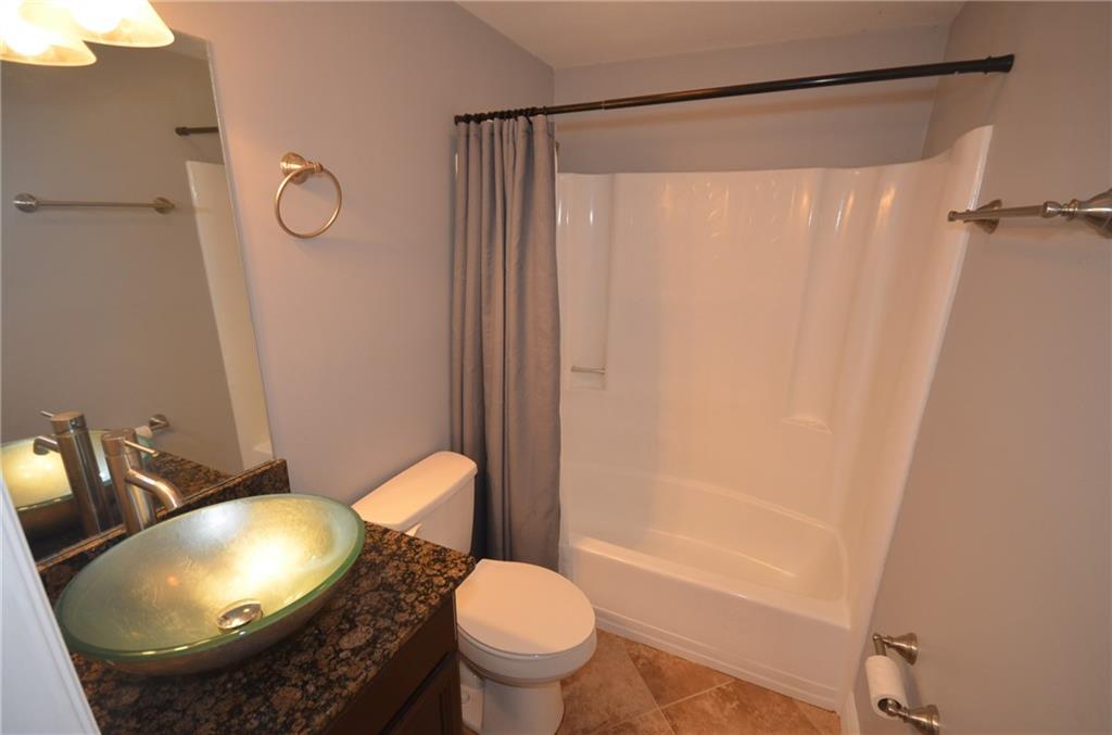 2444 Southeast Washington Street Stuart, FL 34997 - Photo 9 of 13 a bathroom with a sink toilet and shower