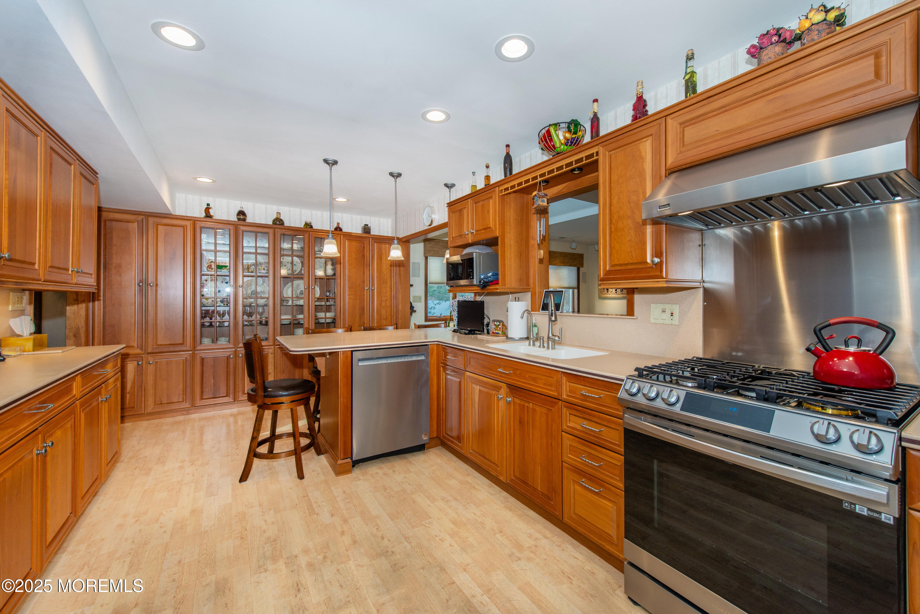 4 Maxwell Lane Manalapan, NJ 07726 - Photo 6 of 32 a kitchen with stainless steel appliances kitchen island granite countertop a stove a sink and a refrigerator