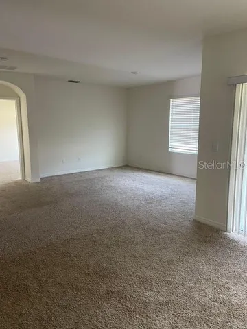 a view of a big room with windows and closet