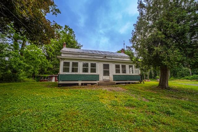 Back of house with a lawn