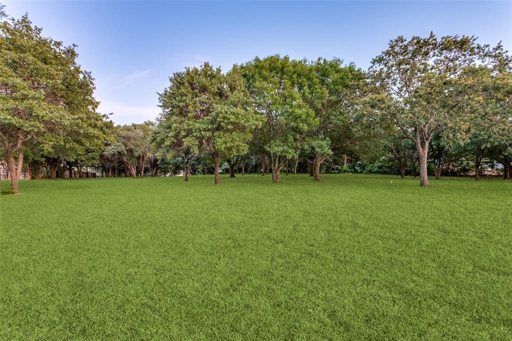 262 Turner Warnell Road Mansfield, TX 76063 - Photo 7 of 17 a view of a green field with trees in the background