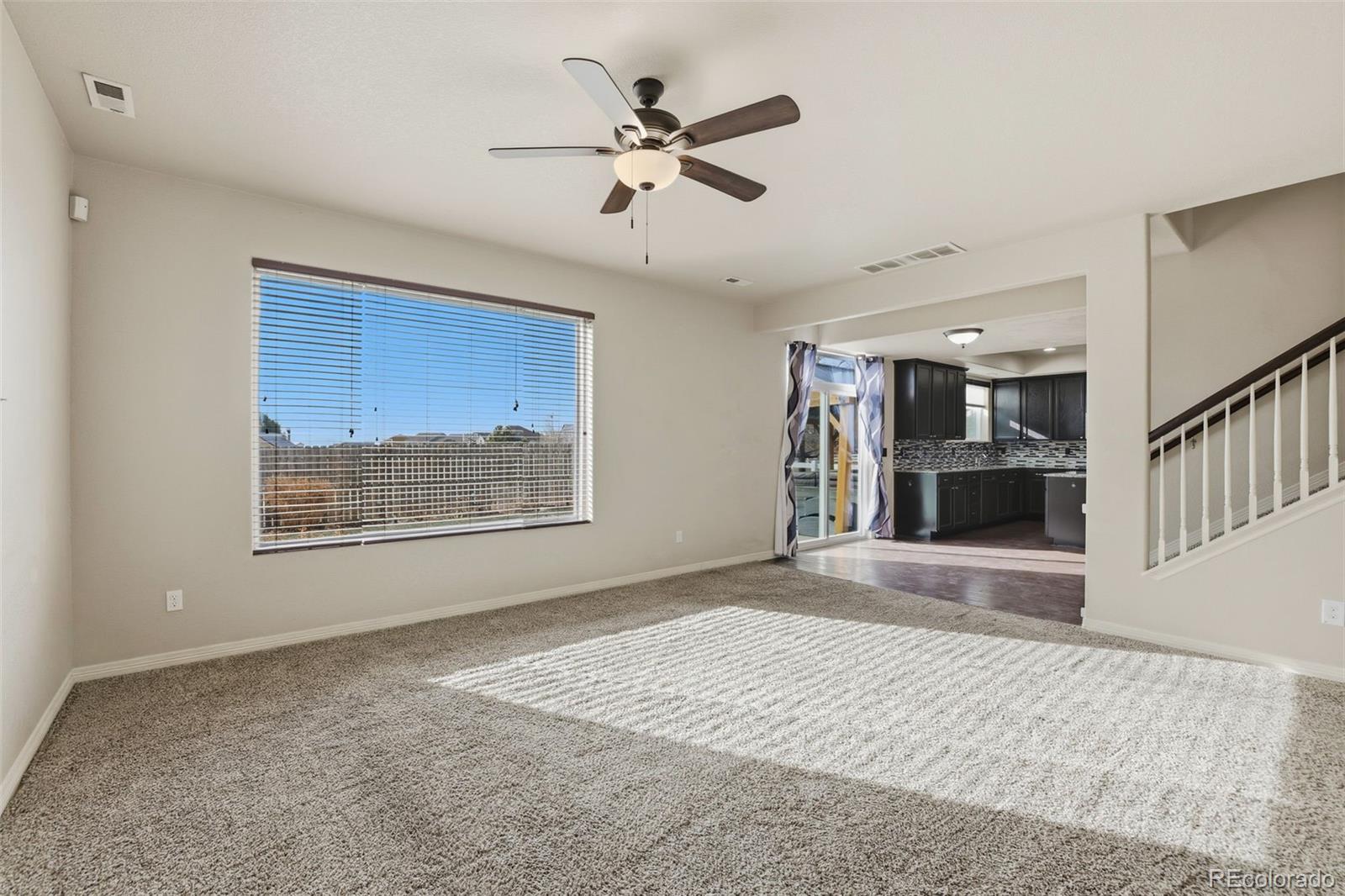 2224 Reed Grass Way Colorado Springs, CO 80915 - Photo 13 of 45 a view of an empty room with a window and kitchen view