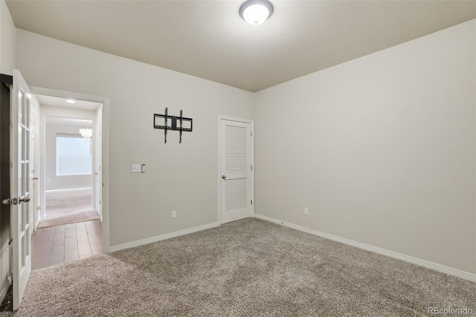 2224 Reed Grass Way Colorado Springs, CO 80915 - Photo 21 of 45 an empty room with a door