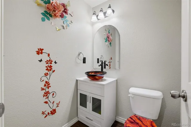 a room with a potted plant on the wall and a fireplace