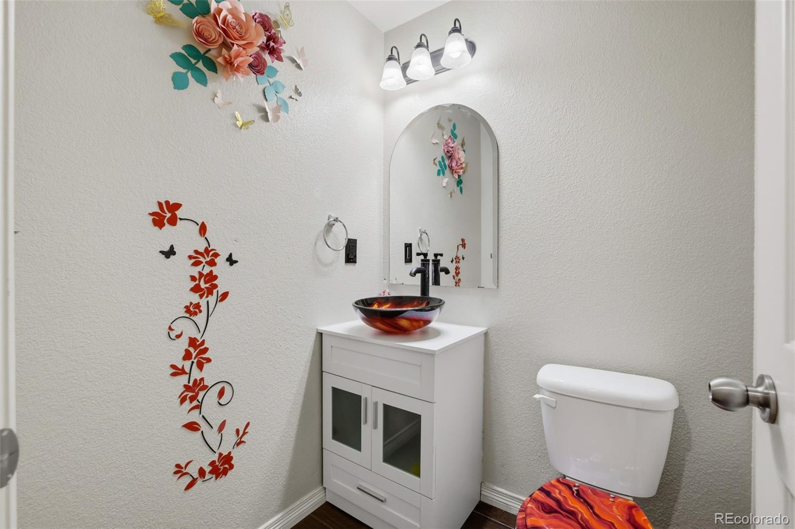 2224 Reed Grass Way Colorado Springs, CO 80915 - Photo 22 of 45 a room with a potted plant on the wall and a fireplace