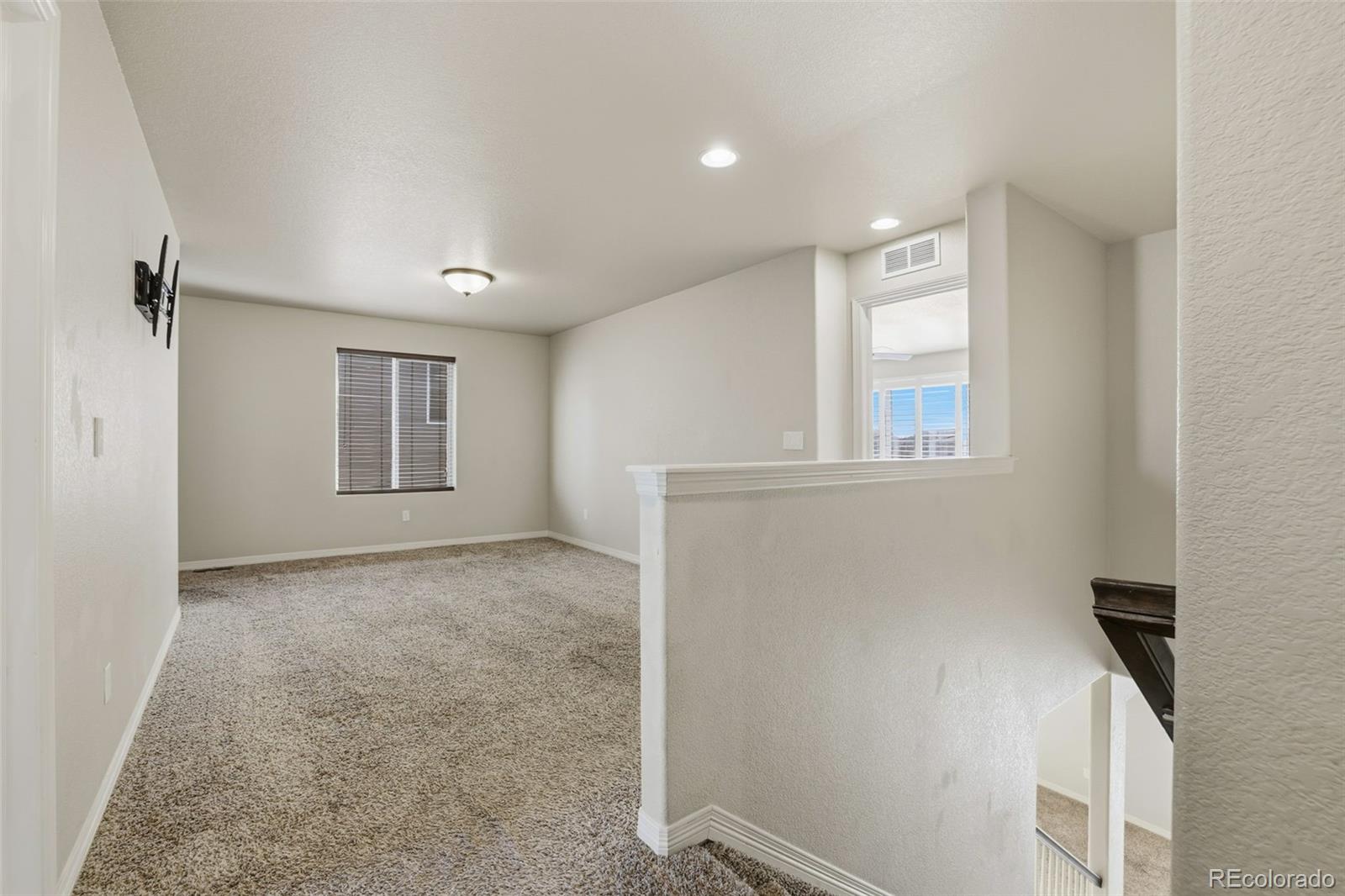 2224 Reed Grass Way Colorado Springs, CO 80915 - Photo 23 of 45 a view of an empty room with a window