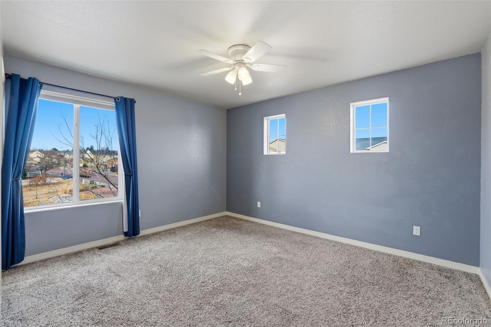 2224 Reed Grass Way Colorado Springs, CO 80915 - Photo 34 of 45 an empty room with windows and closet