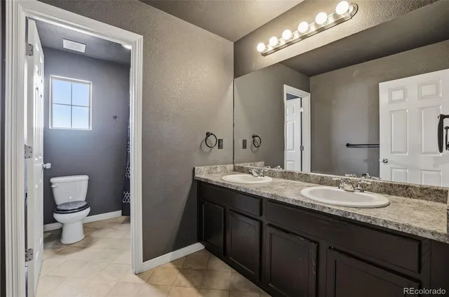 a bathroom with a tub shower and vanity