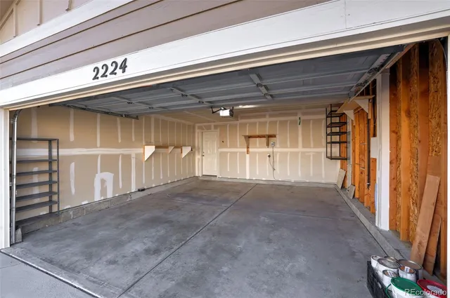 a view of a house with entryway and wooden fence