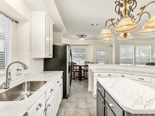 a kitchen with a sink a stove and cabinets