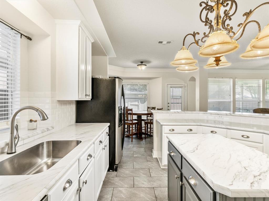 a kitchen with a sink a stove and cabinets