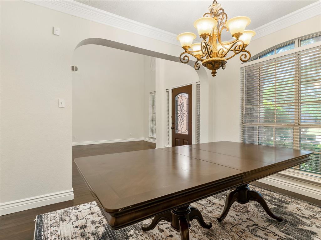 7121 Raintree Way Denton, TX 76210 - Photo 11 of 38 a view of a dining room with furniture and a chandelier