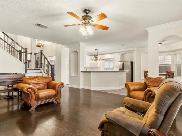 a living room with furniture and kitchen view