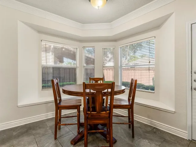 a view of a dining room with furniture and a window