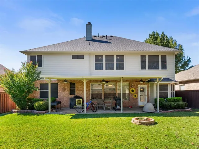 a front view of a building with a garden and plants