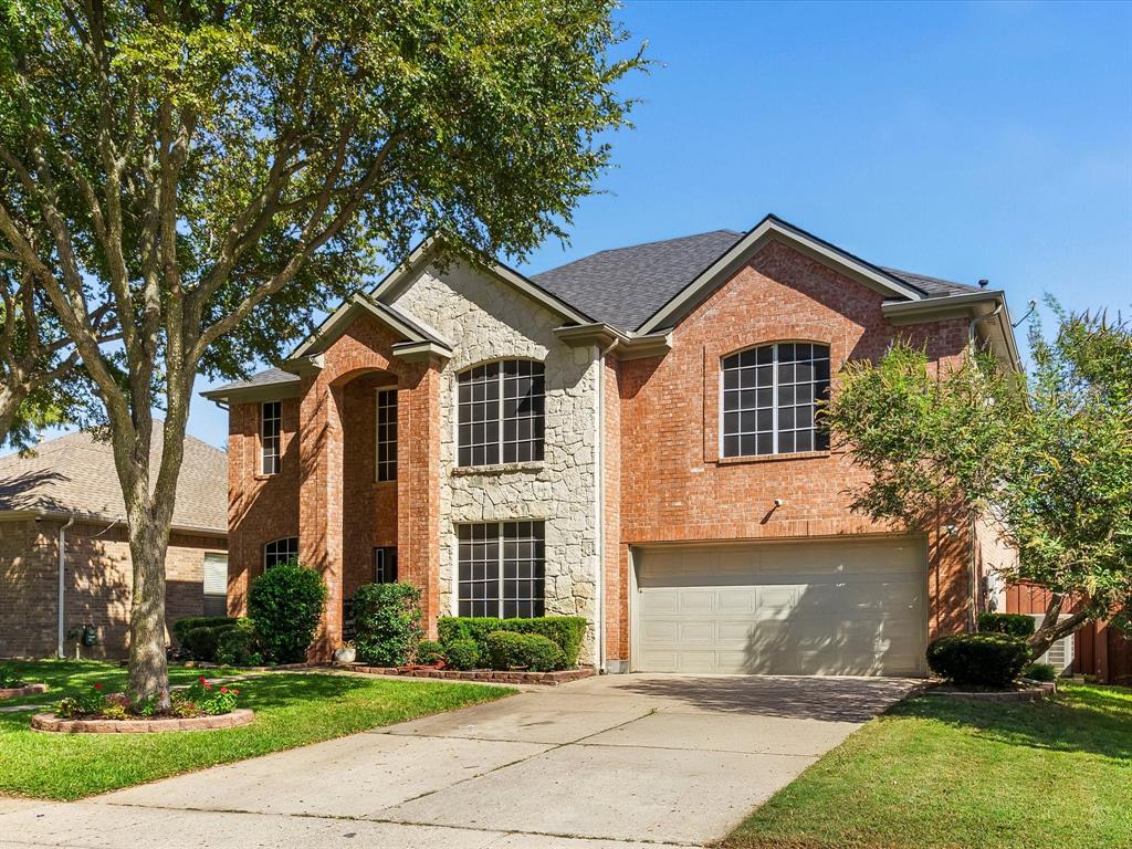 7121 Raintree Way Denton, TX 76210 - Photo 6 of 38 a front view of a house with a yard