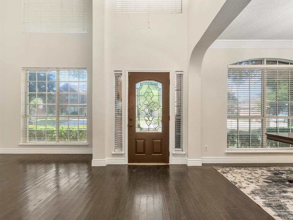 7121 Raintree Way Denton, TX 76210 - Photo 7 of 38 an empty room with wooden floor and windows