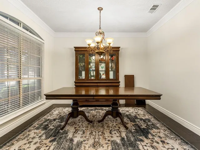 a living room with a table and a chandelier