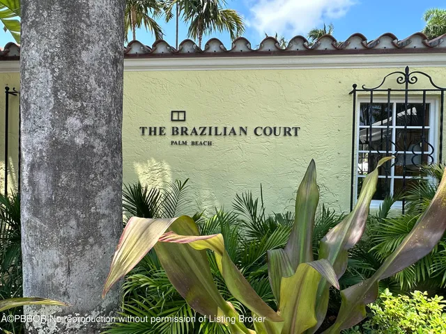 a view of a swimming pool with lawn chairs