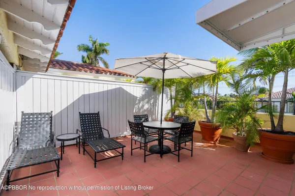 an outdoor space with furniture and umbrella