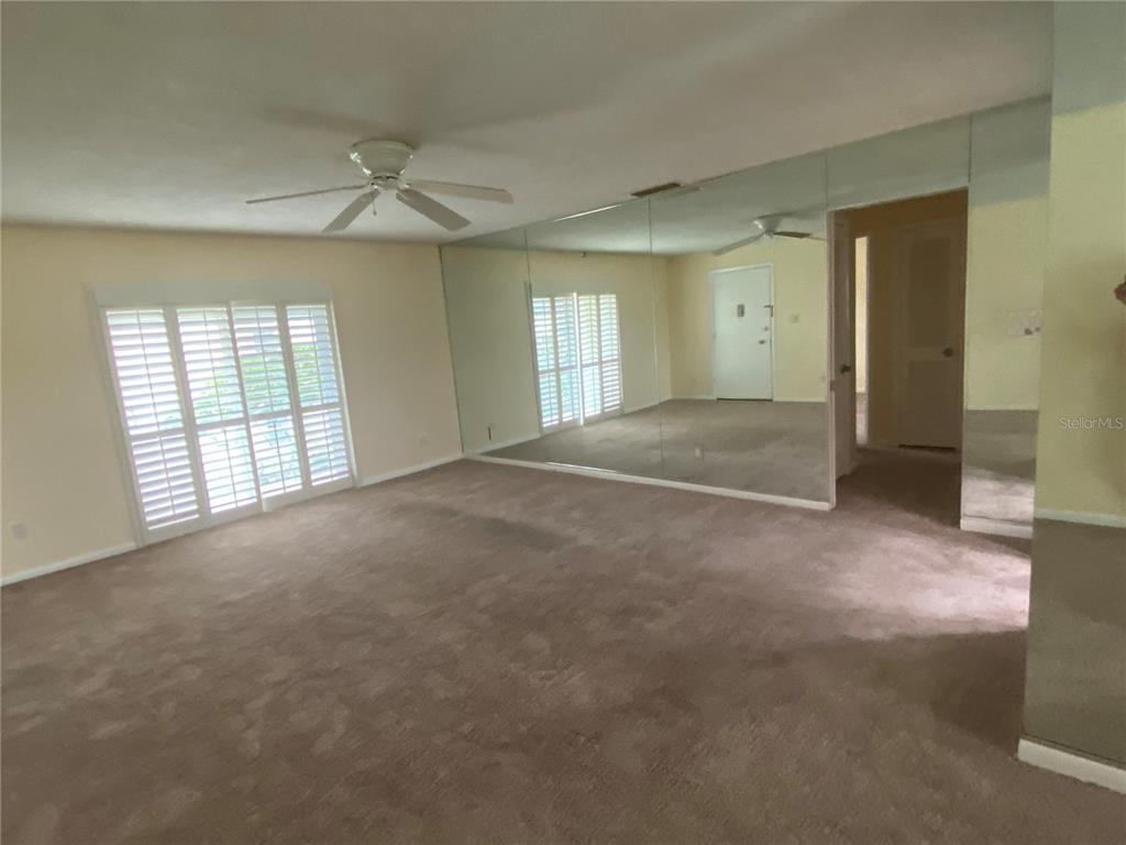 1500 Gay Road, Unit 17D Winter Park, FL 32789 - Photo 4 of 34 an empty room with windows and chandelier fan