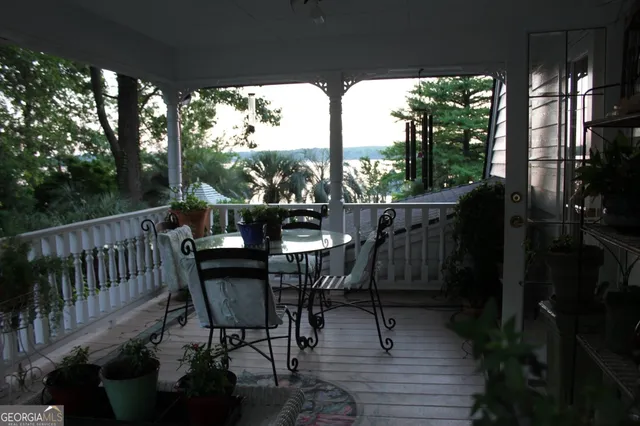 a view of a chairs and table in patio with a yard