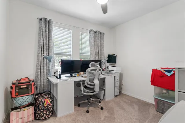 a view of a workspace with furniture and a window