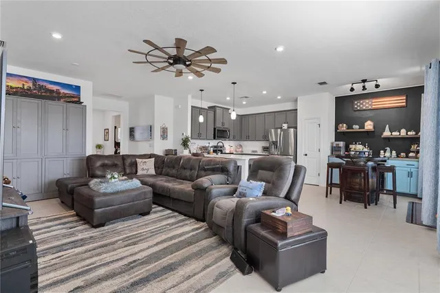 a living room with furniture and kitchen view