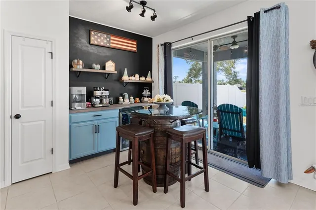 a view of a dining room with furniture and a potted plant