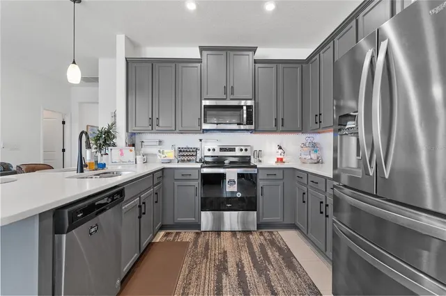 a kitchen with a sink stove and refrigerator