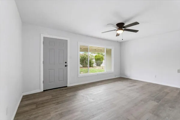 a view of room with hardwood floor and ceiling fan