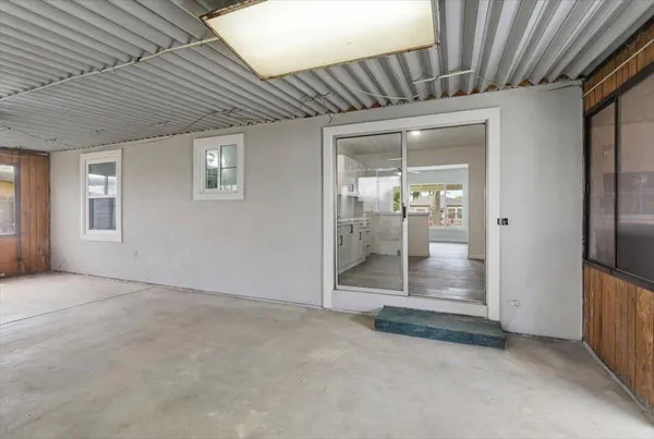 an empty room with sliding door and wooden floor