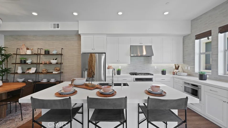 a kitchen with a dining table cabinets and chairs