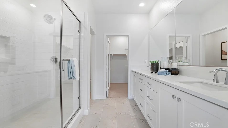 785 Walnut Terrace Montebello, CA 90640 - Photo 16 of 36 a spacious bathroom with a double vanity sink a mirror a shower and vanity