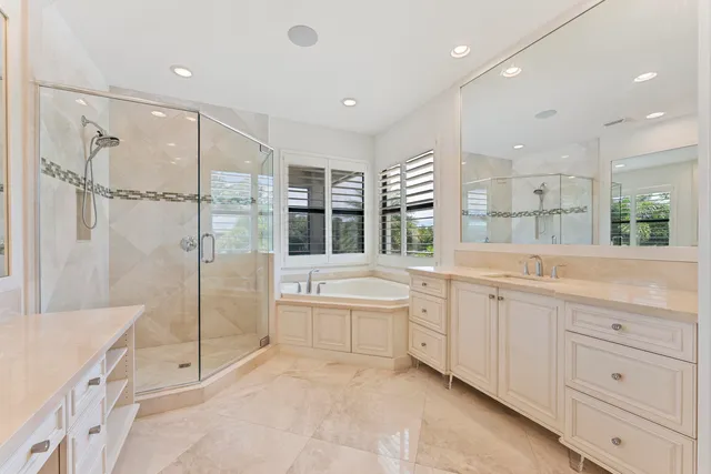 a bathroom with a granite countertop sink mirror and shower