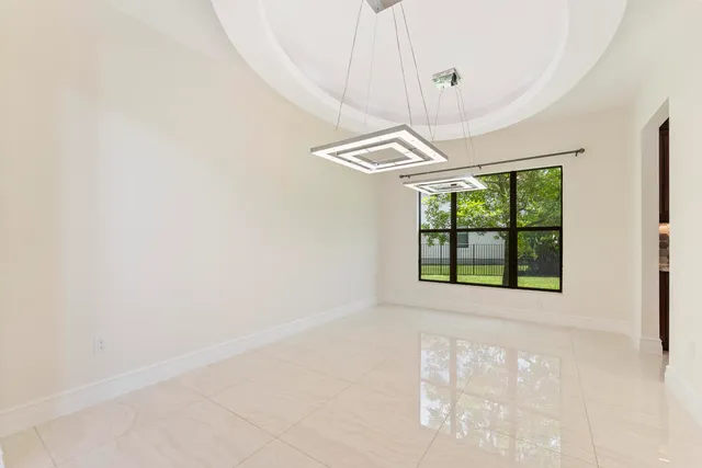 a view of an empty room with wooden floor and closet