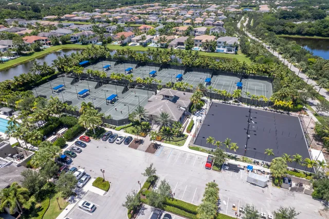 an aerial view of a pool yard lake and outdoor seating
