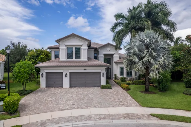 a view of staircase with lots of frames on wall and a window