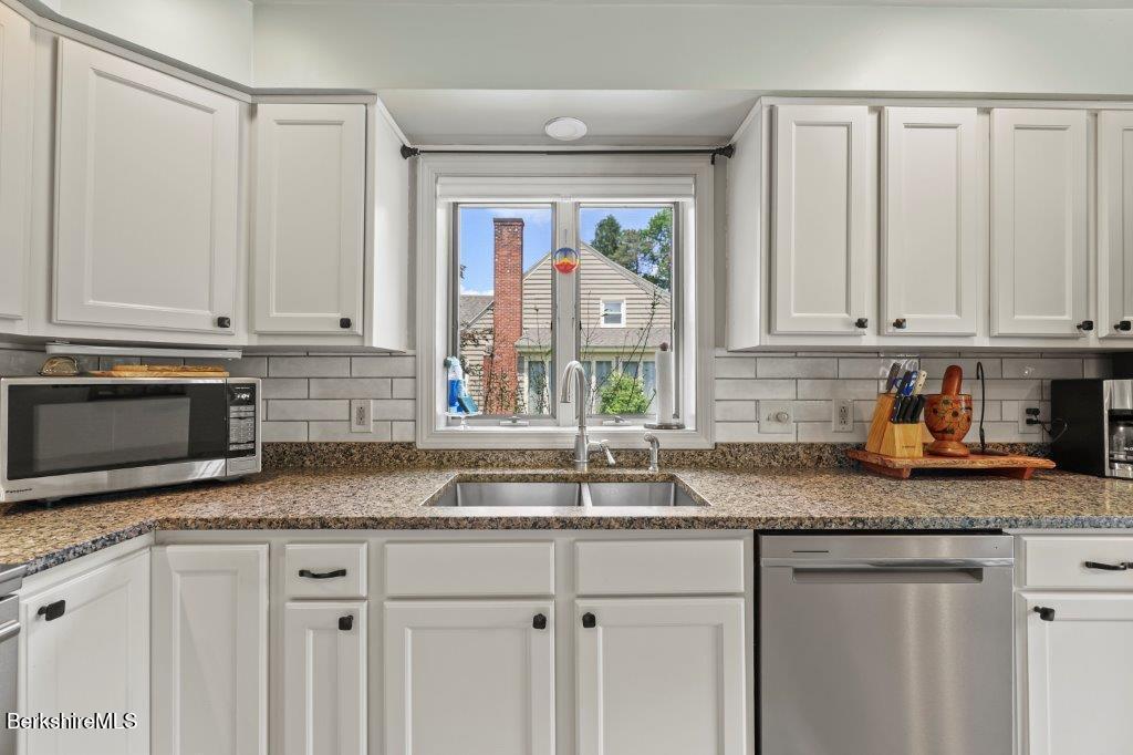 33 Eleanor Road Pittsfield, MA 01201 - Photo 16 of 45 a kitchen with granite countertop stainless steel appliances white cabinets granite counter tops and a wooden floors