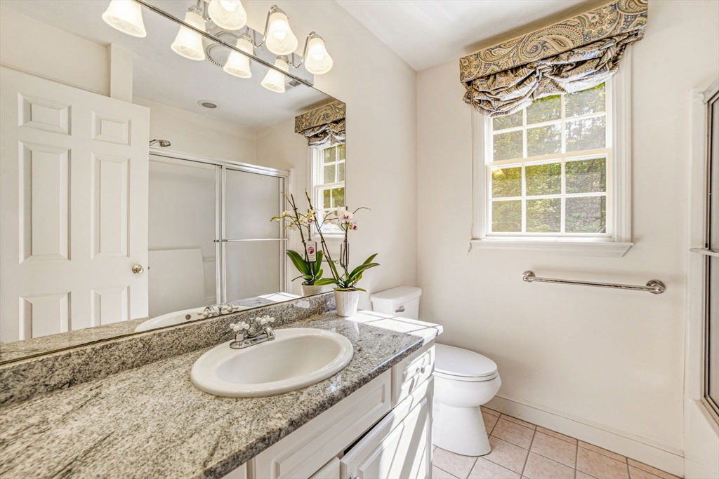 85 Cedarwood Road Boxborough, MA 01719 - Photo 30 of 41 a bathroom with a granite countertop sink a toilet and a mirror